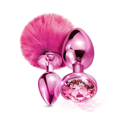 Set of two metallic pink butt plugs, one with a fluffy pom pom tail and the other with a large faceted jewel base.