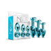 Three-piece Nixie metal butt plug trainer set in blue with jeweled bases displayed next to packaging box.