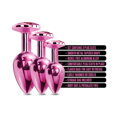 Three pink metal butt plugs in graduated sizes with jeweled tops and product feature text on a white background.