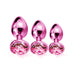 Set of three graduated pink metal butt plugs with faceted gem bases for beginner to advanced training.