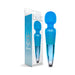 Blue Nixie rechargeable wand massager with textured silicone head and metallic ombre handle next to its packaging box.