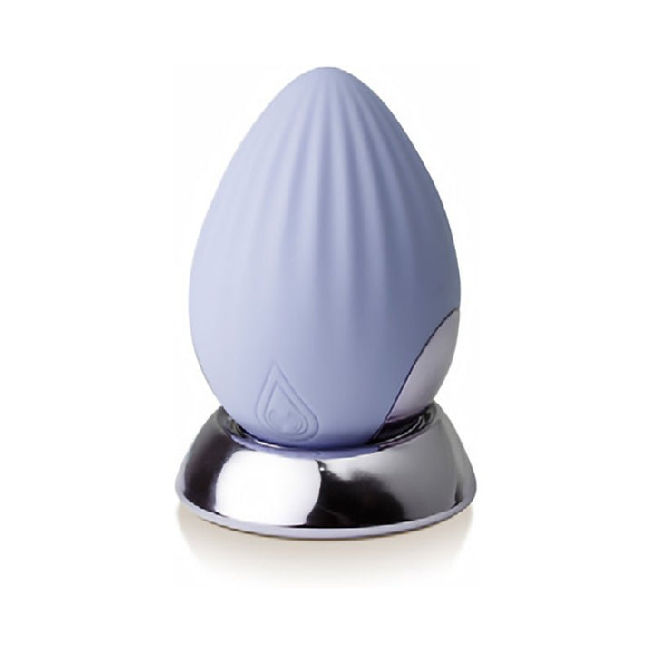Cornflower blue Niya 4 Palm Held Massager with textured silicone surface on a reflective silver base.