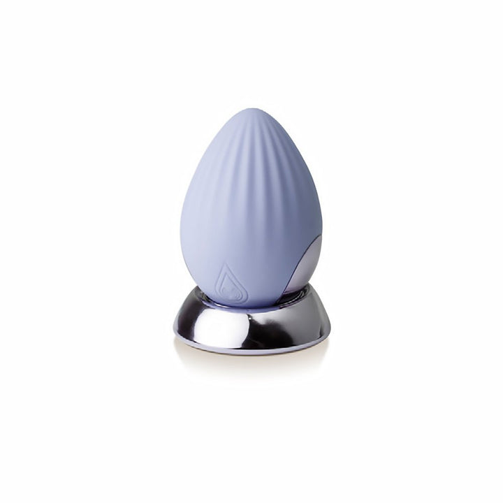 Cornflower blue rechargeable silicone palm-held massager with textured surface on a reflective silver base.