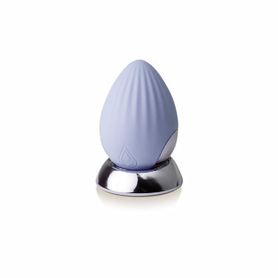 Cornflower blue rechargeable silicone palm-held massager with textured surface on a reflective silver base.