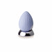 Cornflower blue rechargeable silicone palm-held massager with textured surface on a reflective silver base.