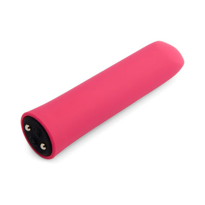 Pink silicone-coated bullet vibrator with angled tip and magnetic USB charging port on white background.