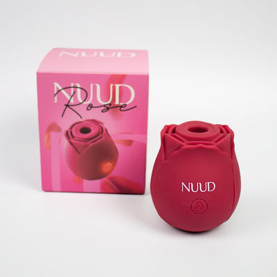 Red rose-shaped pulsing vibrator with NUUD branding next to its pink packaging box.
