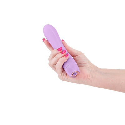 Hand holding a light purple silicone vibrator with a smooth, curved design and gold-accented base.