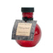Round red glass bottle of Olivia's Boudoir Unforgettable massage and body oil with black cap and decorative label.