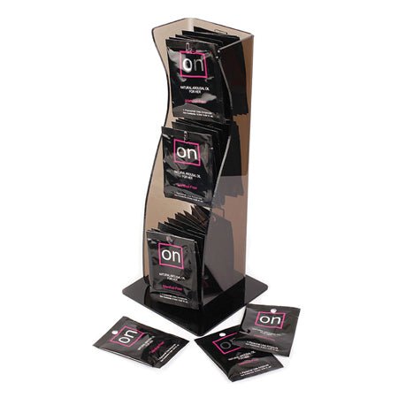 Display stand with multiple On Natural Arousal Oil For Her packets in black packaging, each 0.3ml size.