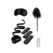 Black and white bed bindings restraint kit with adjustable cuffs, satin blindfold, feather tickler, and two white candles.