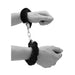 Black furry wrist cuffs connected by a metal chain, shown worn on a person's wrists.