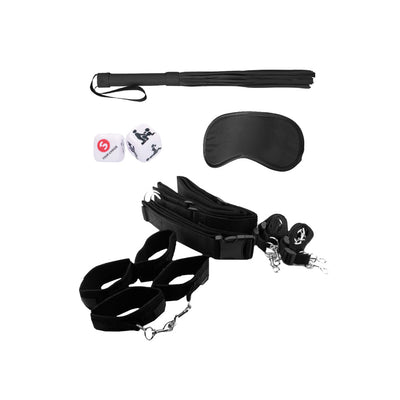 Black bondage restraint kit with adjustable straps, wrist and ankle cuffs, blindfold, flogger, and dice on white background.