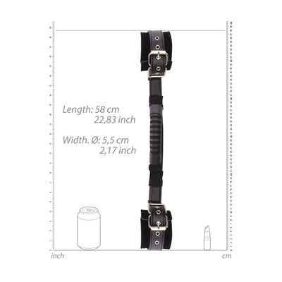 Black and white bonded leather handcuffs with adjustable straps and a central handle, shown with size measurements.