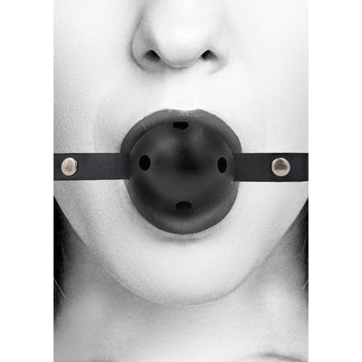Close-up of a person wearing a black breathable ball gag with bonded leather straps and ventilation holes.