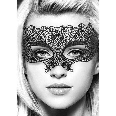 Close-up of a woman wearing an intricate black lace eye mask with a delicate, Venetian-inspired design.
