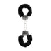 Black and white furry handcuffs with metal chain and quick-release button for comfortable restraint play.