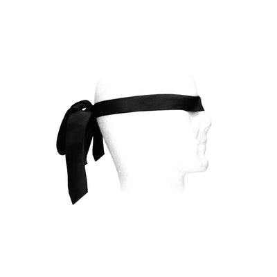 Black satin bondage tie wrapped and tied around a white mannequin head as a blindfold.