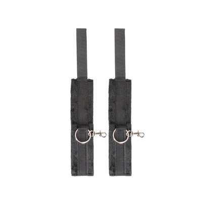 Pair of black velcro cuffs with soft lining and metal rings for secure hand or ankle restraint.