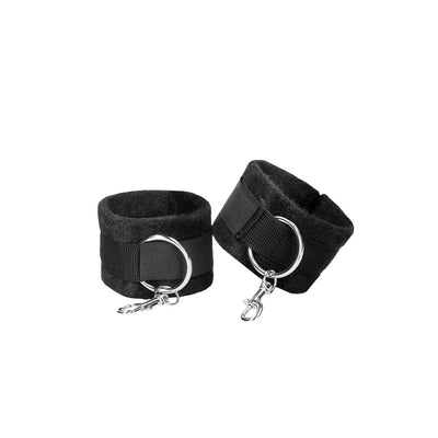Black velcro cuffs with soft lining and metal rings for adjustable hand or ankle restraint.