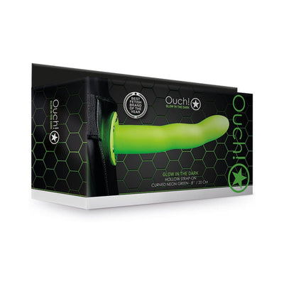 Ouch! curved hollow strap-on in neon green with adjustable black waistband shown on black hexagon-patterned packaging.
