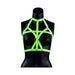Black mannequin wearing a green glow-in-the-dark adjustable bra harness with strappy bondage design.