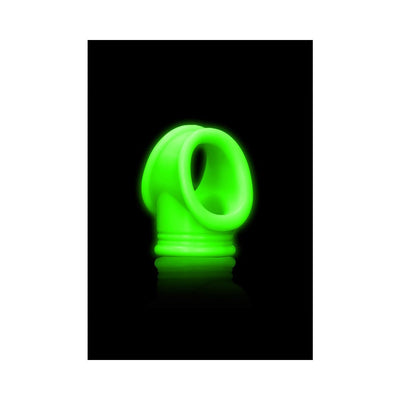 Glow-in-the-dark green silicone cock ring and ball strap with a smooth, flexible design on black background.