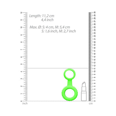 Green glow-in-the-dark silicone cock ring and ball strap with size measurements and lipstick for scale.