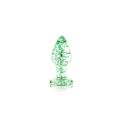 Clear glass butt plug with green glow-in-the-dark speckles and a flared base for safe use.