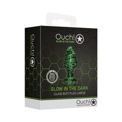 Packaging box of Ouch! Glow in the Dark large glass butt plug with green glowing design on black hexagon background.