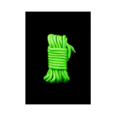 Coiled bright green glow-in-the-dark rope with metal tips on a black background.