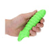 Hand holding a bright green, textured stretchy penis sleeve with a secure ball strap, glow-in-the-dark feature.