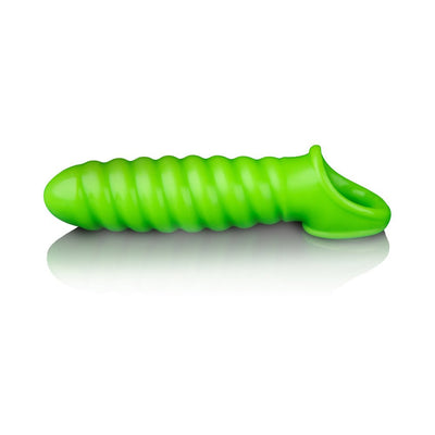 Green glow-in-the-dark stretchy penis sleeve with spiral texture and secure ball strap on white background.