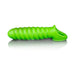 Green glow-in-the-dark stretchy penis sleeve with spiral texture and secure ball strap on white background.