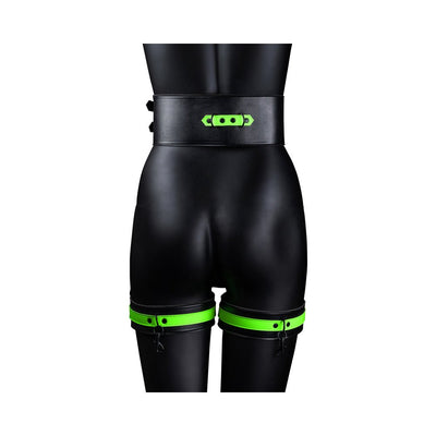 Black mannequin wearing Ouch! Glow in the Dark green and black thigh cuffs and matching wide belt from the back.
