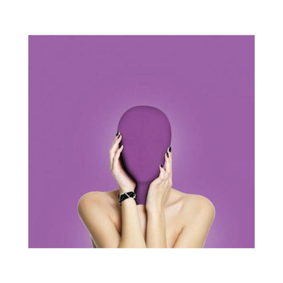 Person wearing a smooth purple spandex subjugation mask covering the entire head against a matching purple background.