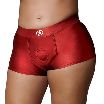 Close-up of red vibrating strap-on boxer shorts with a front O-ring detail and elastic waistband on a model.