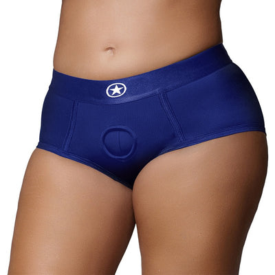 Close-up of a person wearing royal blue mid-rise vibrating strap-on brief with a star logo on the waistband.