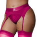 Close-up of pink vibrating strap-on thong with adjustable garters worn with matching thigh-high stockings.