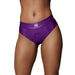 Front view of purple vibrating strap-on thong with removable butt straps on model, featuring elastic waistband and O-ring opening.