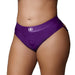 Close-up of purple vibrating strap-on thong with removable back straps worn on model, featuring elastic waistband and front O-ring opening.