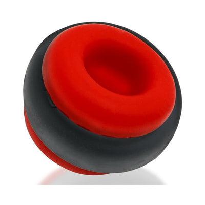 Red and black silicone ballstretcher with a hollow center and textured grip ring design.