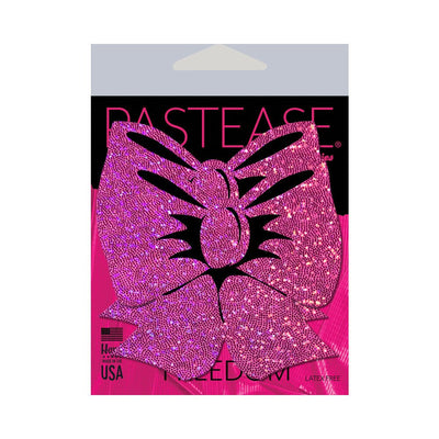 Hot pink glitter bow-shaped nipple pasties on Pastease branded packaging with USA made and latex-free labels.