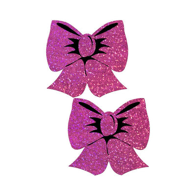 Pair of hot pink glittery bow-shaped nipple pasties with black detailing on a white background.