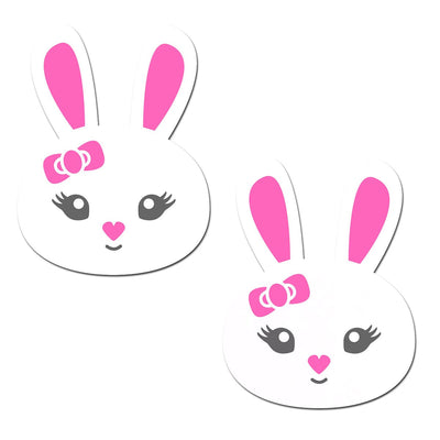Pair of white bunny-shaped pasties with pink ears, heart-shaped noses, and pink bows on a white background.