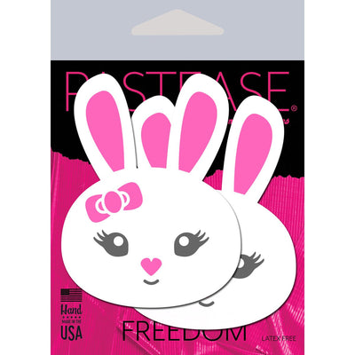 White bunny-shaped nipple pasties with pink ears, heart-shaped nose, and a bow, displayed on Pastease branded packaging.