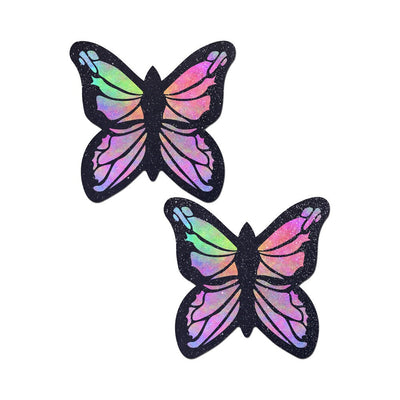 Pair of butterfly-shaped rainbow twinkle pasties with black outlines and glitter accents on a white background.