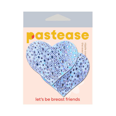 Silver crystal heart-shaped nipple pasties on pastel pink Pastease packaging with "let's be breast friends" text.