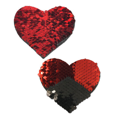 Red and black reversible sequin heart-shaped adhesive pasties with shimmering finish