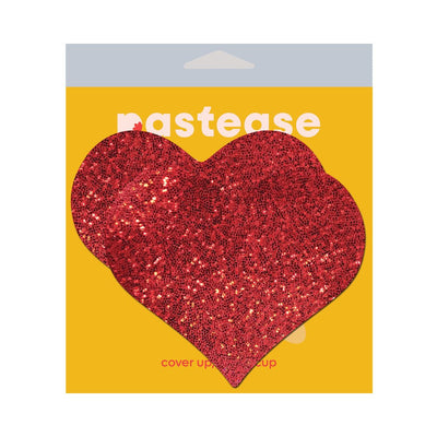 Red glitter heart-shaped fuller coverage adhesive pasties on yellow Pastease packaging.